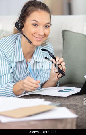 concentrated woman wearing headset with microphone Stock Photo