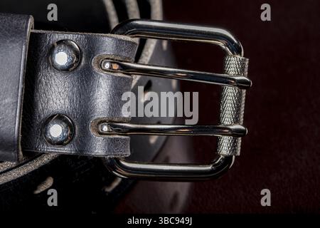 Black leather belt on a dark background. Leather products Stock Photo