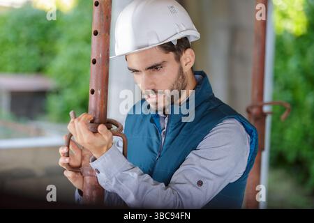 male builder checking pipes state Stock Photo