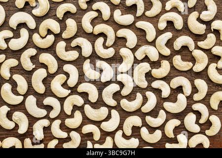 Background texture of cashew nuts on a rustic grunge wood Stock Photo
