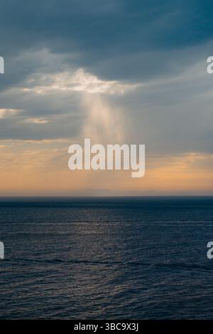 Sunbeams breaking through storm clouds over the sea, Menorca Stock Photo