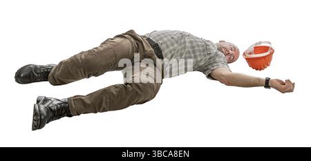 Construction worker lying down after workplace accident Stock Photo