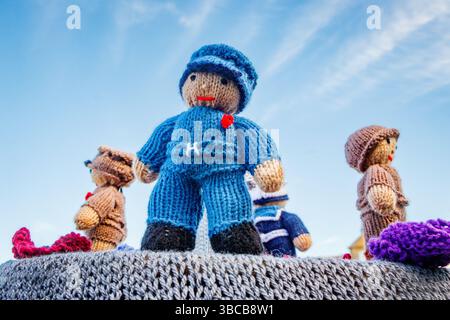 close up of knitted wool sailor and other figures  on top of post box Northumberland Stock Photo