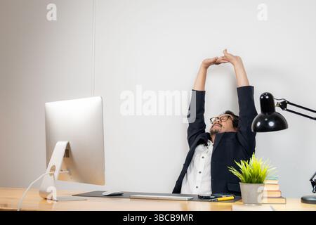 Stretching at work, essential for physical and mental well-being during long hours of desk job Stock Photo