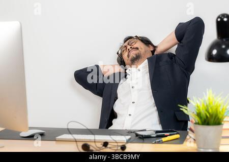 Stretching at work, essential for physical and mental well-being during long hours of desk job Stock Photo