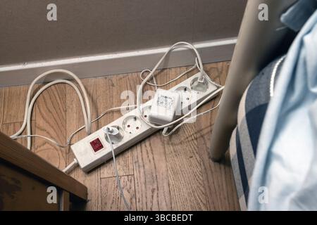 A dusty electric extension cord  full of power plugs can be a fire hazard. Stock Photo