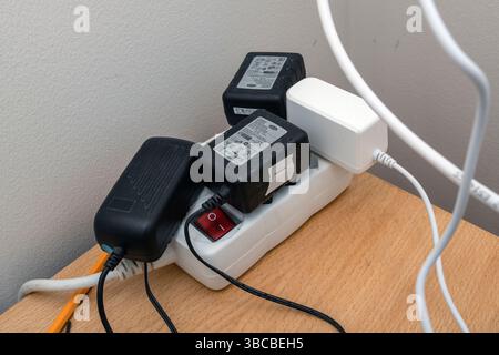 A dusty electric extension cord  full of power plugs can be a fire hazard. Stock Photo
