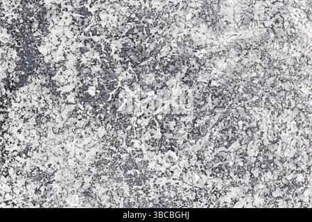 Stone granite texture background. Abstract grey and white rough surface. Natural stone pattern closeup. Hard rock for construction. Grunge backdrop. Stock Photo