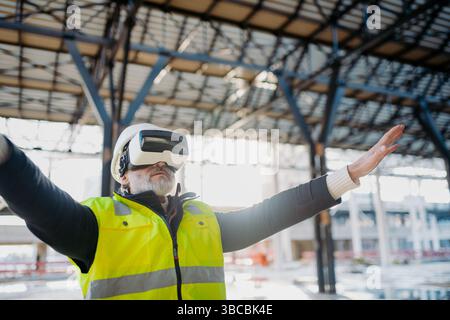 Engineer using virtual reality to inspect building progress. Stock Photo