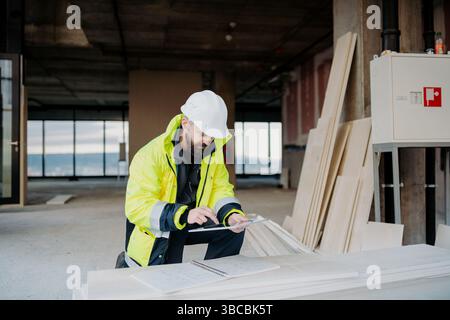 Construction site manager using digital tablet to inspect building progress. Stock Photo