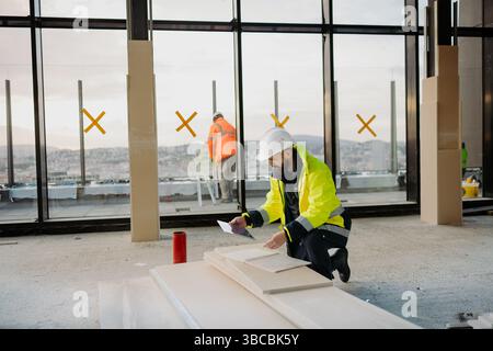 Construction site manager using digital tablet to inspect building progress. Stock Photo