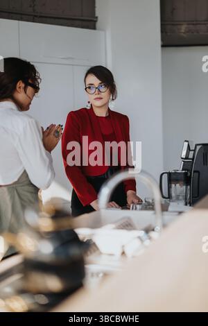 Multiracial business workers having a conversation in a modern office Stock Photo