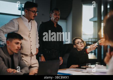 Multicultural team strategizing project ideas in modern office setting Stock Photo