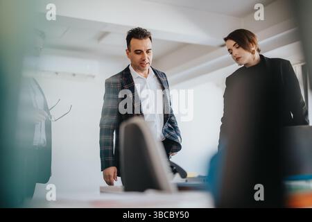 Business professionals discussing ideas and collaborating in a modern office setting Stock Photo