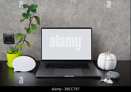 Laptop with blank screen with supplies and gadgets. Responsive design template. Stock Photo