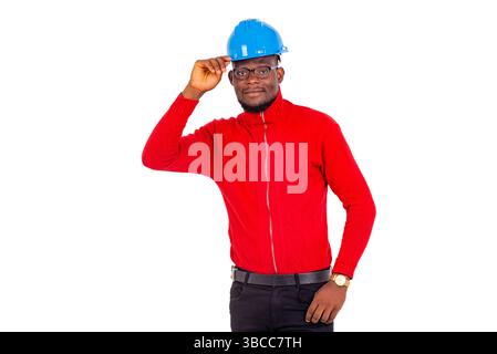 young male construction engineer wearing blue safety helmet while smiling. Stock Photo