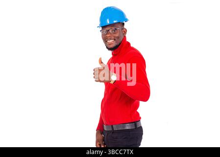 engineer man wearing safety helmet standing over white background showing gesture of approval and looking at camera smiling. Stock Photo