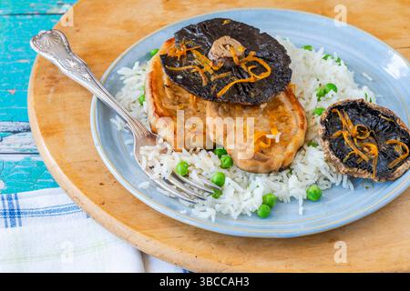 Orange glazed pork escalopes and portobello mushrooms with rice Stock Photo