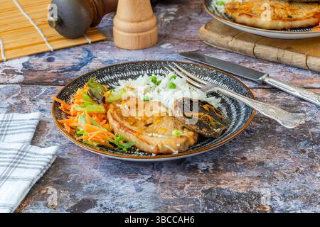 Orange glazed pork escalopes and portobello mushrooms with rice Stock Photo