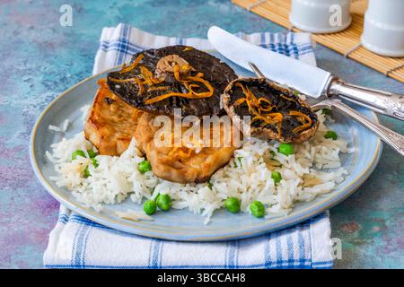 Orange glazed pork escalopes and portobello mushrooms with rice Stock Photo