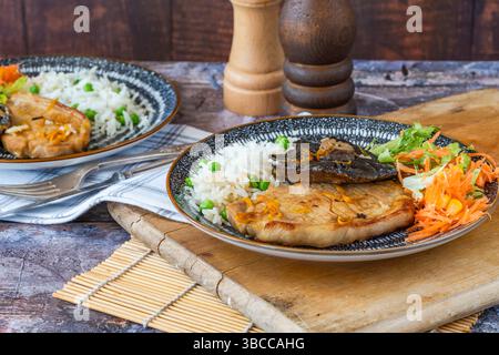 Orange glazed pork escalopes and portobello mushrooms with rice Stock Photo