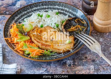 Orange glazed pork escalopes and portobello mushrooms with rice Stock Photo
