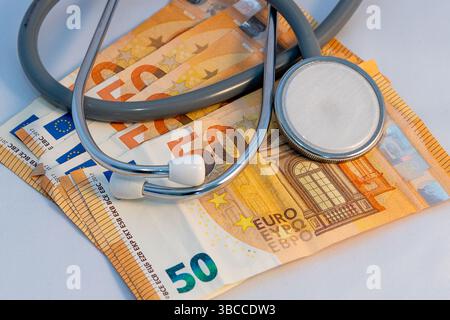 Stethoscope on €50 Bank Notes on a White Background. Stock Photo