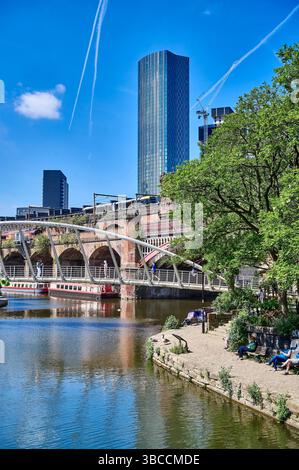 Merchants Bridge at Castlefield with rail crossing and Beetham Tower in background Stock Photo