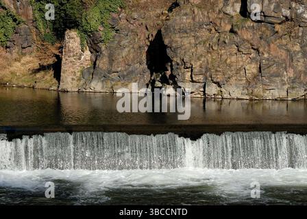 Small waterfall over a weir with light reflections, Germany Stock Photo