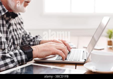 Senior man hands on laptop closeup Stock Photo
