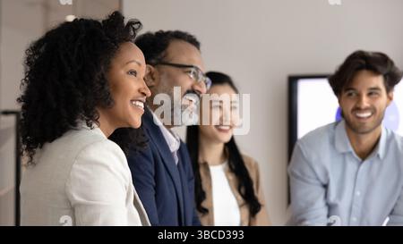 Close up cropped view of four laughing multinational teammates Stock Photo