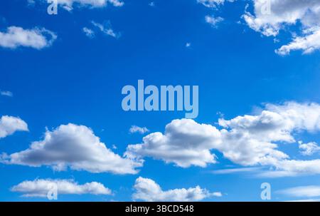 A beautiful blue sky with puffy white clouds. Stock Photo