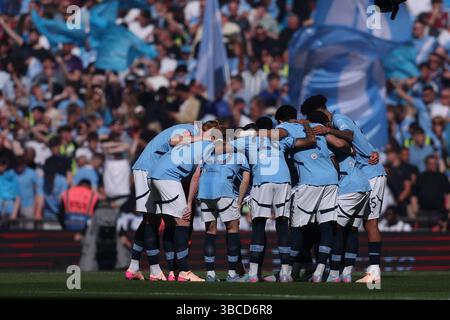 Manchester City team huddle during the Carabao Cup Semi-finals First ...