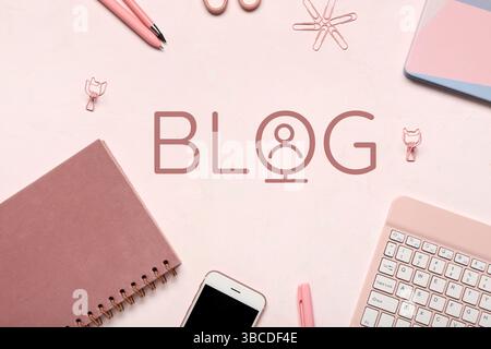 Office supplies and word BLOG on light pink background Stock Photo