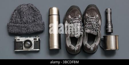Set of items for trekking on grey background Stock Photo