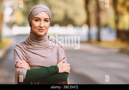 Muslim Woman Wearing Hijab And Modern Clothes Posing Standing Outdoors Stock Photo