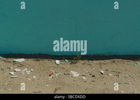 a background the rough structure of an old plastered wall with fallen pieces of plaster Stock Photo