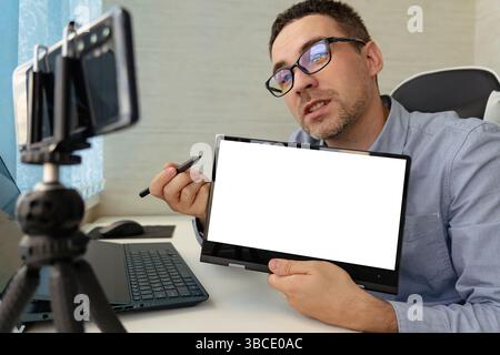 Man Participating In Online Coaching Session Using Laptop. A business coach conducts a training webinar. Lecturer on distance learning. copy space. bl Stock Photo