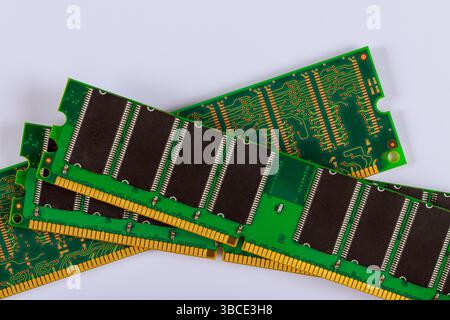 Stacked green circuit boards with black memory RAM chips display electronic components connections. Stock Photo