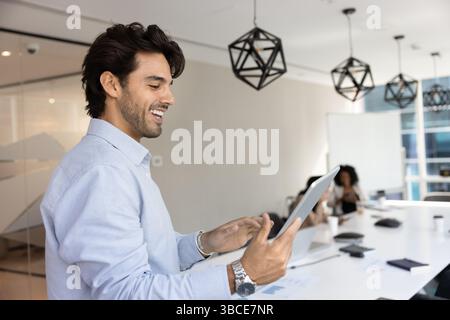 Businessman using digital tablet device standing in conference room Stock Photo