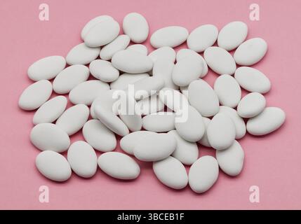 Jordan almonds isolated on pink background. Stock Photo