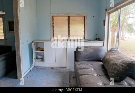 a basic kitchenette, and sandy floors showing signs of long abandonment. Stock Photo