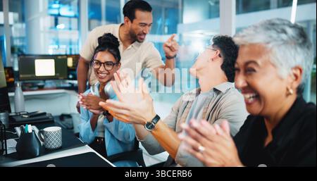 Office, business people and computer with applause for celebration, motivation and coding team. Night, collaboration and programmers with clapping Stock Photo