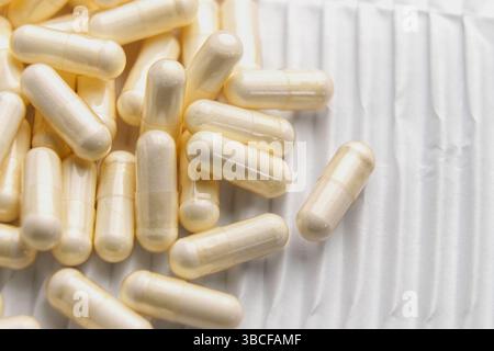 Macro shot of medicine capsules on white corrugated paper. Top view Stock Photo