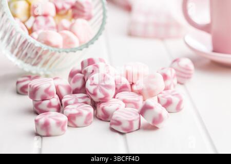 Colorful striped candies on a white table. Stock Photo