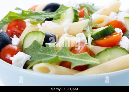 Mediterranean Pasta Salad with Fresh Vegetables and Herbs isolated on white background Stock Photo