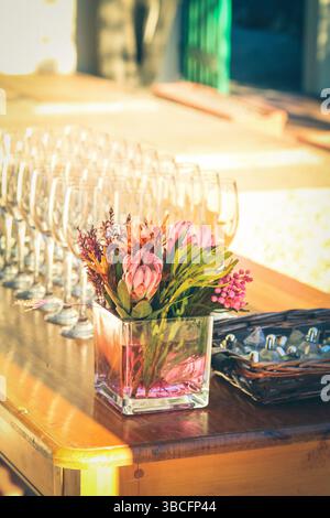 Wooden table set up with champagne flutes Stock Photo