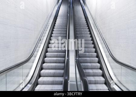 A horizontal view of an empty long escalator in a train station Stock Photo