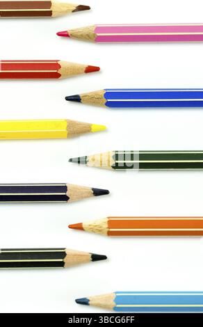 vertical view of colored pencils facing each other on a white background Stock Photo