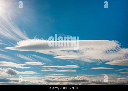 White clouds and  a blue sky on a sunny day Stock Photo